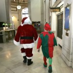 santa-elf-1 Santa Claus and an Elf leave the Capitol Building after testifying before the House Finance Committee; Claus is asking for money from U.S. taxpayers to help fund Christmas this year