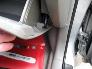 Open the glove box. There's one black screw and some tabs holding it on. Remove the screw with a phillips screwdriver, and it comes off easy.