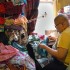 Eugene Tan, who performs regularly at Jacque's drag show and cabaret, works on a costume beside a pile of unused fabric.  Tan said that every time a fabric store has a sale, he ends up purchasing another bolt or two. (Blast staff photo/Adam J. Sell)