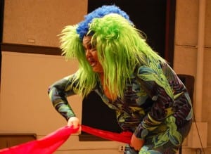 Becca D'Bus, during her drag interpretation of the famous performance art piece "Interior Scroll", extracts a 30-yard banner of fabric from her spandex vagina and passes it through the crowd of 60. (Blast Staff photo/Adam J. Sell)