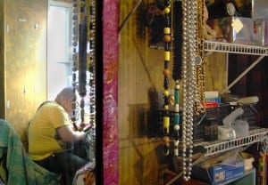 Tan's collection of drag paraphernalia includes several gaudy necklaces, attached to the shelving in his sewing room with rock climbing carabeeners. (Blast Staff photo/Adam J. Sell)