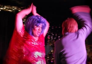 Becca D'Bus, while performing "Total Eclipse of the Heart" at Jacque's Cabaret in the South End, interacts with a patron who chose to get up on stage with her. (Blast Staff photo/Adam J. Sell)