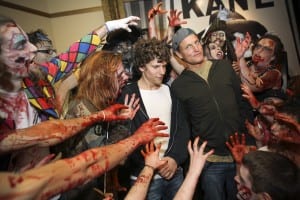 Jesse Eisenberg (center left) and co-star Woody Harrelson (center right) pose for a photo with zombies before a screening of Zombieland at AMC Loews Boston Common Theater in Boston.