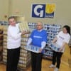 goya gives 1 Jeff Hayward of the United Way, Carlos Mangual of Goya Foods and Tan Shu, a student at Boston University, help sort 75,000 pounds of food at the Reggie Lewis Center on March 16. (Media Credit/John Mottern)