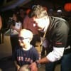 Beckett helps pediatric brain tumor patient William Oulton throw the first ball.