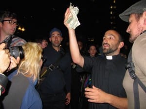 Moments after the Tuesday morning arrests, Rev. Jason Lydon collects donations for bail money. Lydon has been marching with the Occupy Boston protest several times and his congregation, the Community Church of Boston, is a Unitarian Universalist church in the Back Bay vocal in its solidarity with Occupy Wall Street and similar movements across the globe. (Blast Staff photo/John Stephen Dwyer)