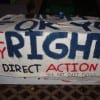 This freshly-painted banner, shown here the night before the arrests, was carried by one of the protestors. (Blast Staff photo/John Stephen Dwyer)