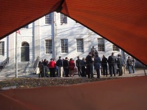 Some tour groups -- such as the one viewed here from inside a tent -- are still being allowed inside the Yard when accompanied by Harvard guides. (Blast Staff photo/John Stephen Dwyer)