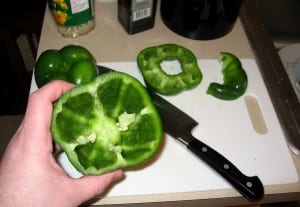 Rinse the peppers and lay them on a cutting board. Using a butchers knife, slice off the tops of each pepper and pull out any seeds. You'll be left with something that looks like a weird tropical cup. 