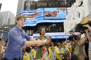 In this photo provided by Nintendo, Nintendo of America's vice president of Corporate Affairs, Denise Kaigler, right, competes against actor Chace Crawford in a match of swordplay at the Wii Sports Resort launch event, Thursday, July 23, 2009, in New York. To commemorate the next chapter in the Wii Sports experience, Nintendo brought in 50 tons of sand to transform Manhattan's famed Military Island into Wuhu Island, the fictional setting featured in the game. (Photo by Diane Bondareff for Nintendo)