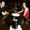 The bartender can't help but be interested in the Guinness. After all, she poured it. (Blast staff photo/Steve Osemwenkhae)