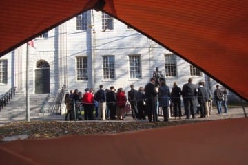Some tour groups -- such as the one viewed here from inside a tent -- are still being allowed inside the Yard when accompanied by Harvard guides. (Blast Staff photo/John Stephen Dwyer)