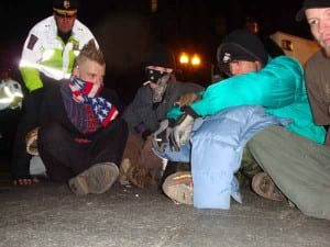 Thirty minutes after the first bout of arrests, Police began arresting a group of five man who planted themselves in the path of a front end loader parked on Atlantic Avenue. (Blast Staff photo/John Stephen Dwyer)