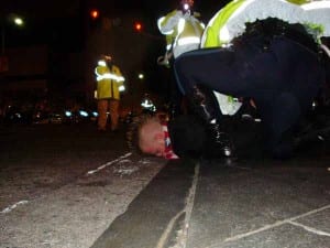 Police place a protestor face-down on Atlantic Avenue before attaching plastic handcuffs and loading him into a transport vehicle. (Blast Staff photo/John Stephen Dwyer)