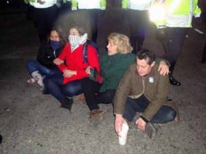 Just when it seemed no more arrests would be made, these four women bolted into the middle of the intersection of Summer Street and Atlantic Ave and sat down until police took them away as well. (Blast Staff photo/John Stephen Dwyer)