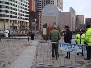 Steve Anderson, Director of Park Operations for the Greenway (in green coat) talks with Captain Bernard O'Rourke as workers move quickly to clean the area where Occupy Boston had been encamped just hours earlier. (Blast Staff photo/John Stephen Dwyer)