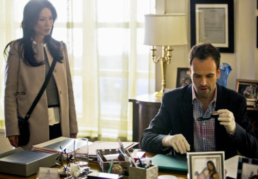 Joan (Lucy Liu) and Sherlock (Jonny Lee Miller) investigate the victims office. 